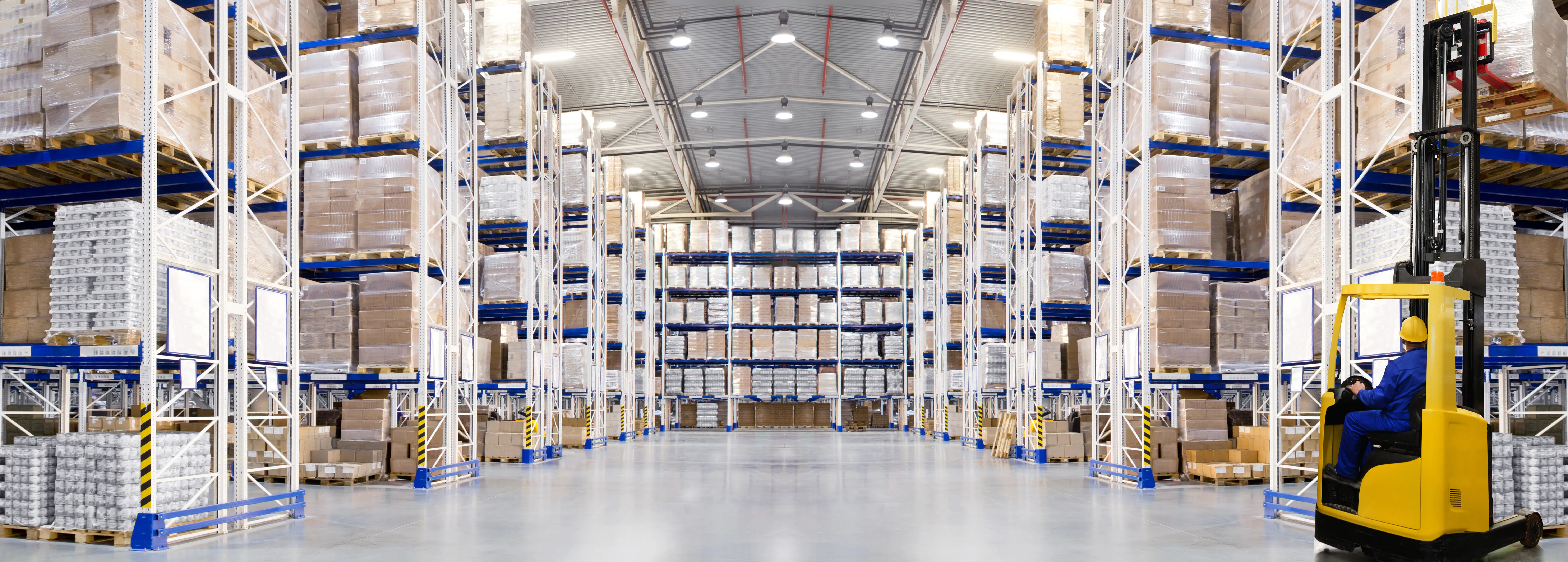 Professional pest control technician inspecting warehouse storage area